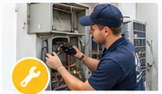 HVAC technician inspecting mechanical heating and cooling equipment